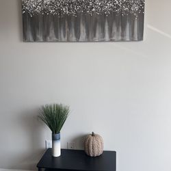 Large wall painting, small plant and small table