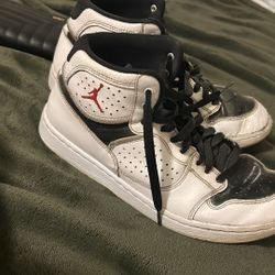 This is a pair of Nike Air Jordan Access basketball shoes in a white, black, and gym red colorway 