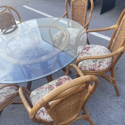 Four Wicker Chairs With Cushions And Wicker Glass Table.
