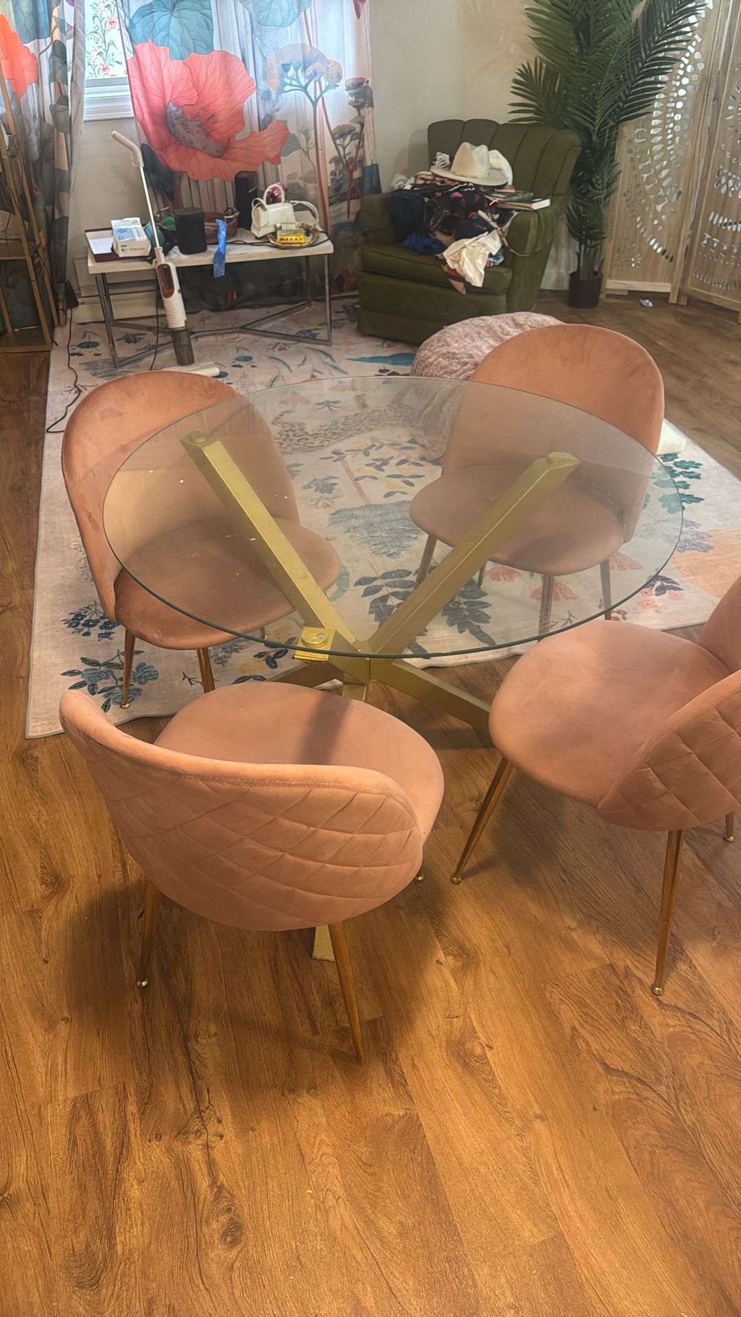 Glass round dining room table with four dusty rose chairs. Also sold this one.
