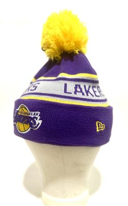 New Era Los Angeles Lakers cuffed knit hat with a pom. The purple, yellow, and white beanie features the Lakers team logo embroidered on the cuff and 