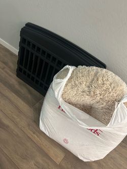 Round fluffy dog bed with pet gate
