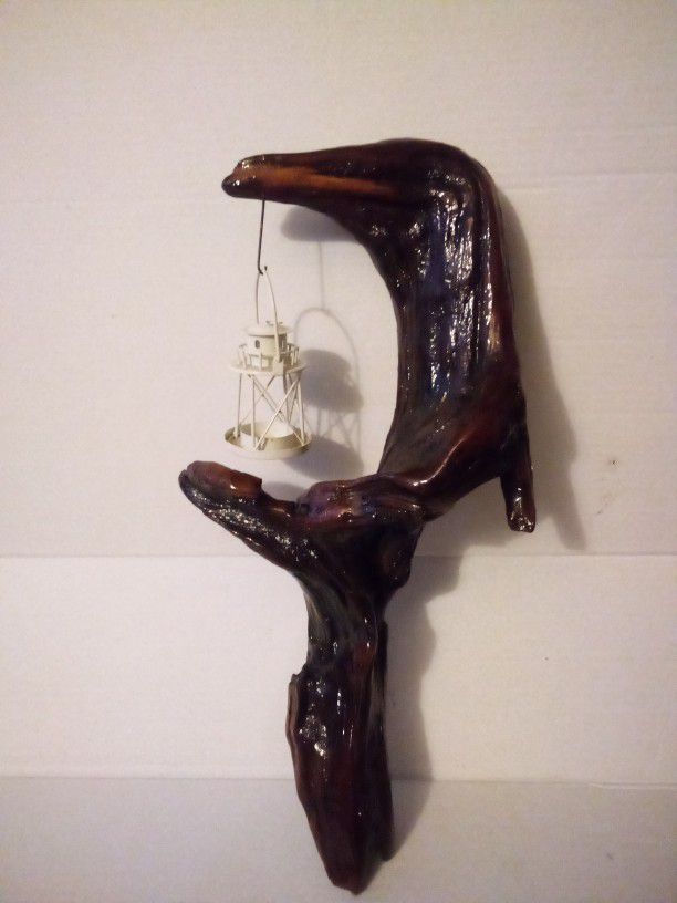 Unique handcrafted driftwood sculpture with candle light lantern.  Has a fastren on the back for hanging. Driftwood is from the banks of the Susquehan
