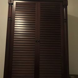 dark wood armoire or wardrobe