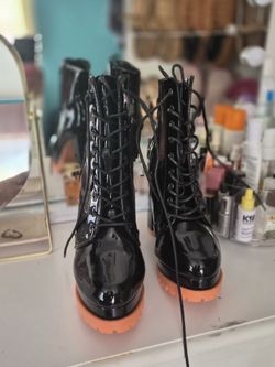 Black patent leather lace-up combat boots