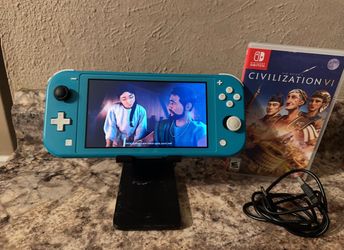 NINTENDO SWITCH LIGHT WITH A GAME AND USB  CHARGER CORD AND HOLDER INCLUDED / WORKING GREAT