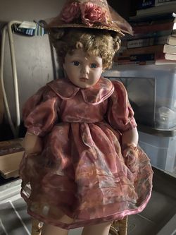 Porcelain Doll with Wicker Chair