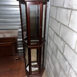 Curio cabinet with multiple glass shelves, wood frame.