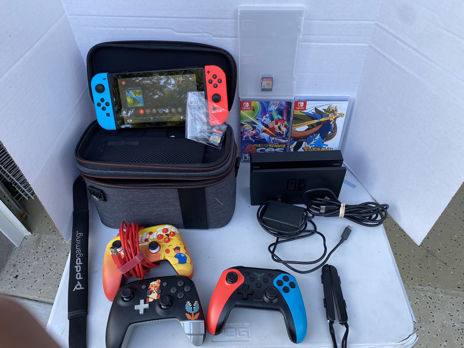 Nintendo switch console w/ 2 joycons, 4 controllers, travel case, and dock for tv w/ cords.  4 games: super Mario 3D all stars,Mario tennis aces,and +
