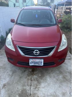 Nissan versa red  4 door
