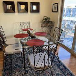 Dining table with six chairs and side pieces and a matching wine rack.