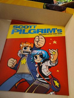 +2

The object in the image is Scott Pilgrim's Precious Little Card Game, a deck-building card game.