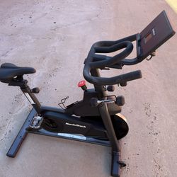 NordicTrack T Series 9 Exercise Bike – 24 lb Flywheel, Tablet Holder, Dumbbells