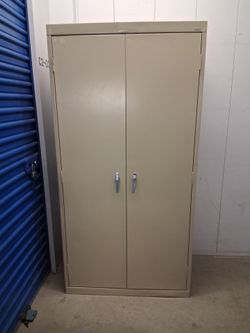 2 doors  metal storage cabinet $ 220