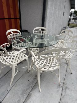Glass top metal table and 6 chairs $280