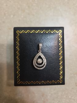 10 k White Gold Diamond Pendant.  Weight is 1.7 grams