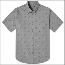 Authentic Balenciaga short sleeve button-up shirt. Gray color with all-over Balenciaga logo print. 