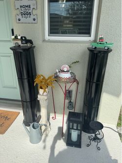 2 Blk Hollow columns, Beige column, red multi, Stan lantern, Black, men, candle, stand water, buckets, and two cars