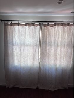 Beige linen curtains with black metal curtain rod