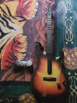 Old  ps2.  Controller and  guitar  for ps2  no game tho to thr guitar  take both