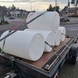 Fifty five and thirty gallon plastic drums