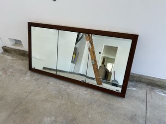 60-inch wide, tri-view medicine cabinet with a wood frame