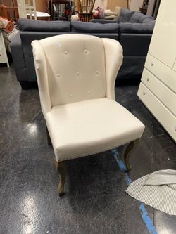 Cream-Colored Wingback Chair with Button Tufting