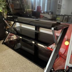 50 inch long by 23 1/2 inch tall black glass TV stand