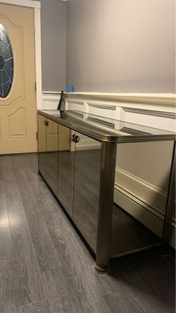 Mirrored credenza/ brass colored edging