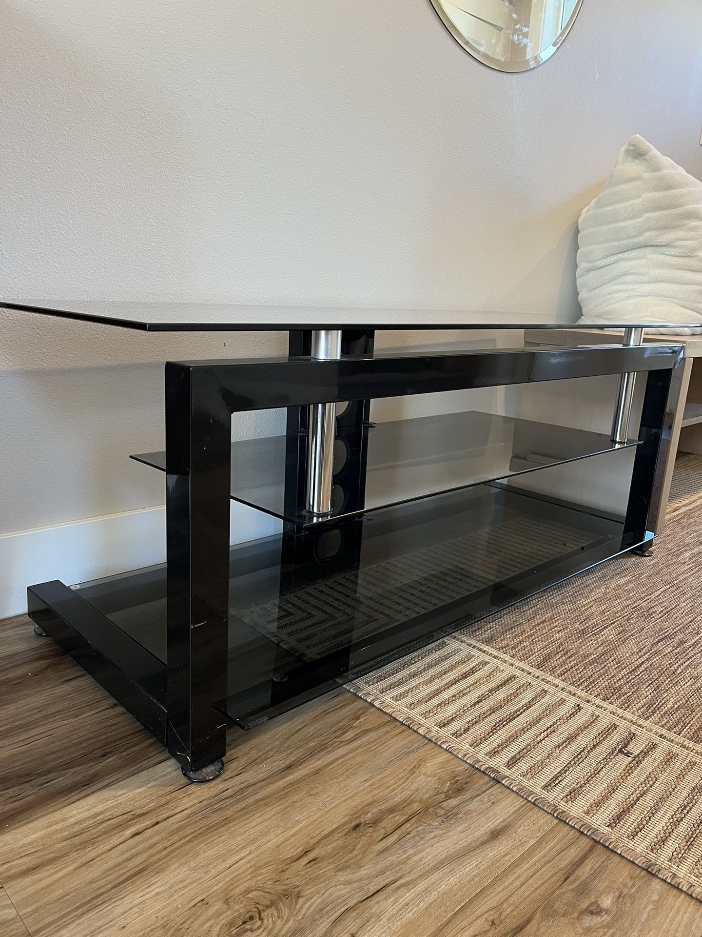 black and metal TV stand with a glass