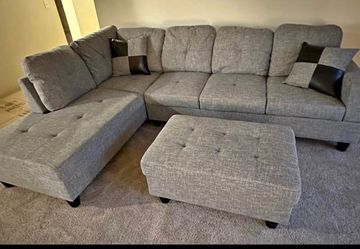 Gray linen sectional couch and ottoman