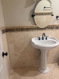 Porcelain pedestal sink, mirror, Wall mount light,faucet, drain and towel racks all matching