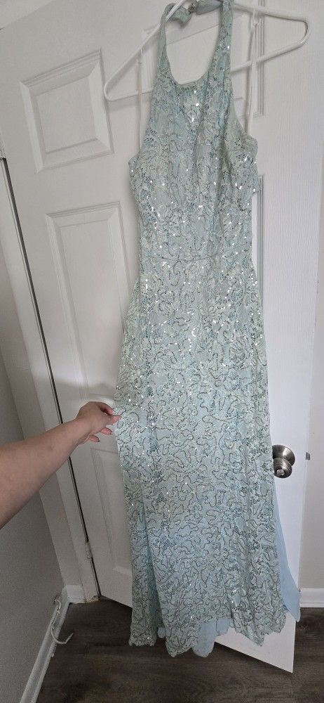This is a light blue, sequined lace evening gown.
