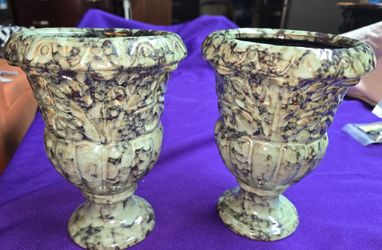 Set of 2 Vintage Ceramic Pedestal Urn Featuring a Striking Green and Black Mottled Spatter Glaze and Embossed Floral Relief Detailing.    M3D103