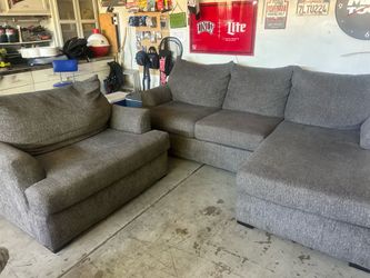 Grey sectional and oversized chair