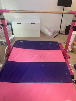 Pink gymnastics bar with pink and purple mat( adjustable )