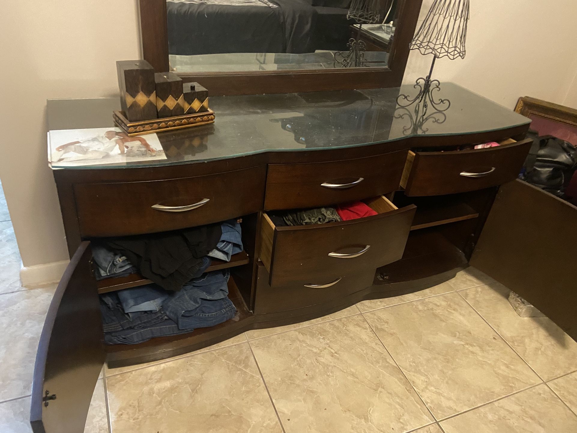 Dresser with mirror, solid wood, with glass on it to protect top, dark brown,3 drawers and shelves, great condition, perfect size, this is quality not