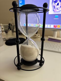 Black metal and white sand glass timer decoration