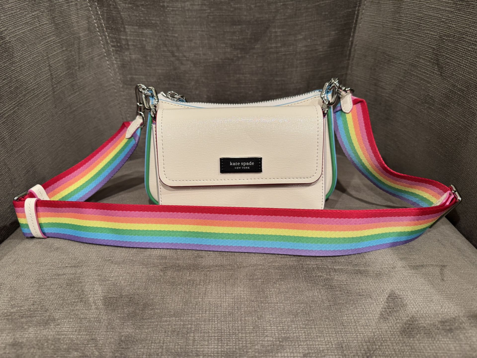 Kate Spade Double Up crossbody in Saffiano leather with rainbow trim. It includes an optional pouch that you can wear with the bag (or use on its own)
