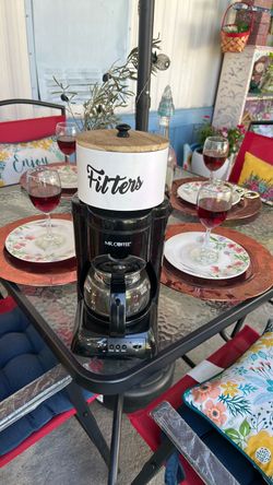 Coffee maker with filters storage