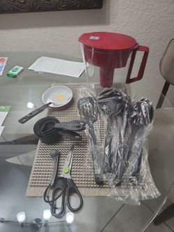 6- black new Cooking Utensils, new egg pan and spatula, measuring cups teaspoons and scissors in a Brita water pitcher all for $12