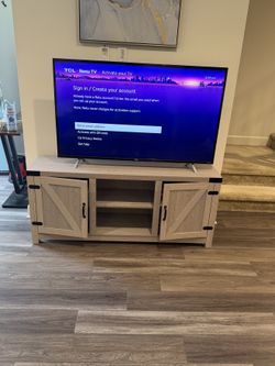 TCL Roku TV with Wooden TV Stand