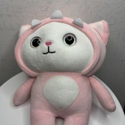 This is a plush toy in the shape of a cat wearing a dinosaur costume.