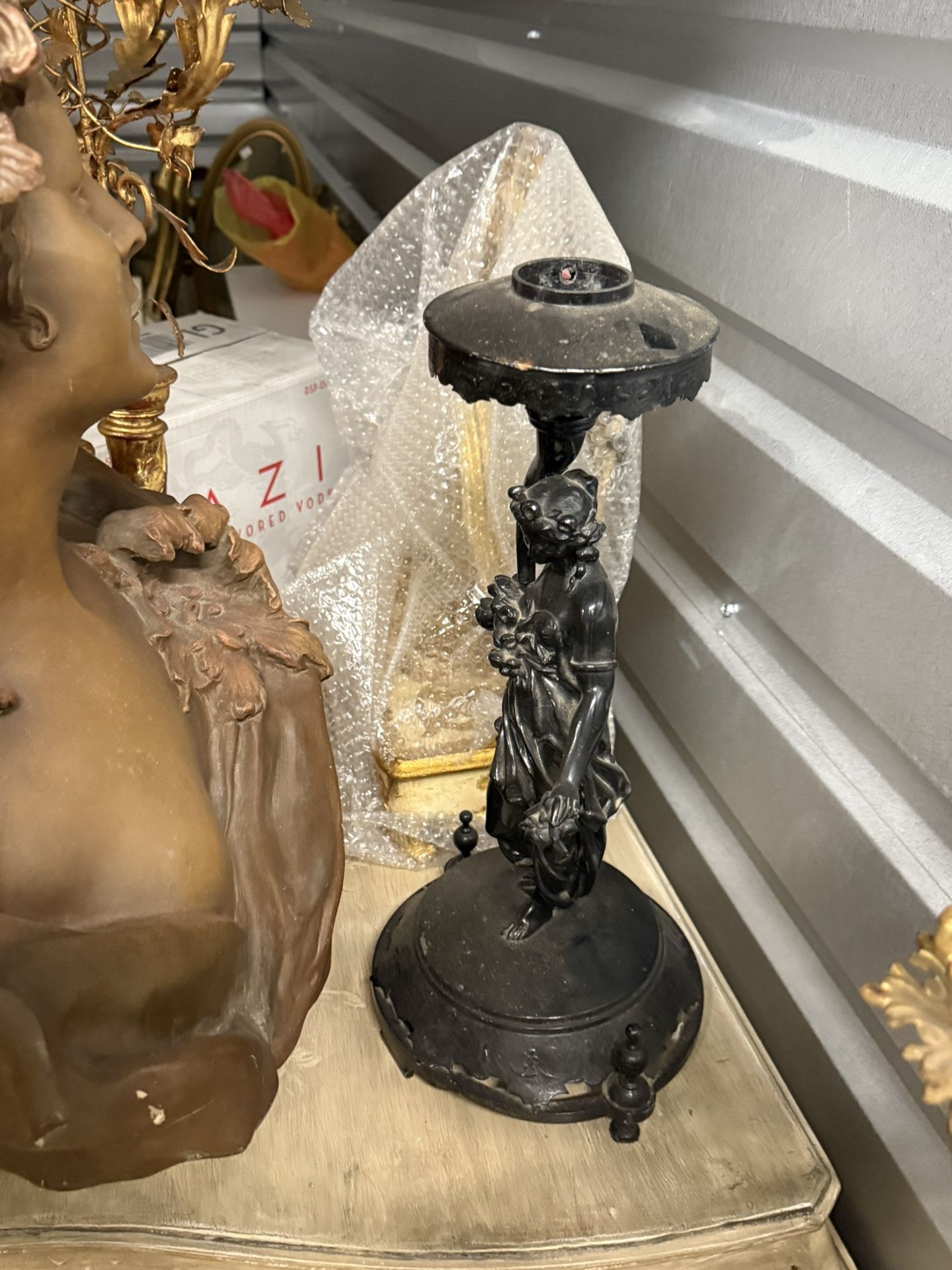 A cast metal Art Nouveau female figure candlestick holder. Candlestick holders have been used for centuries to provide light and enhance ambiance in h