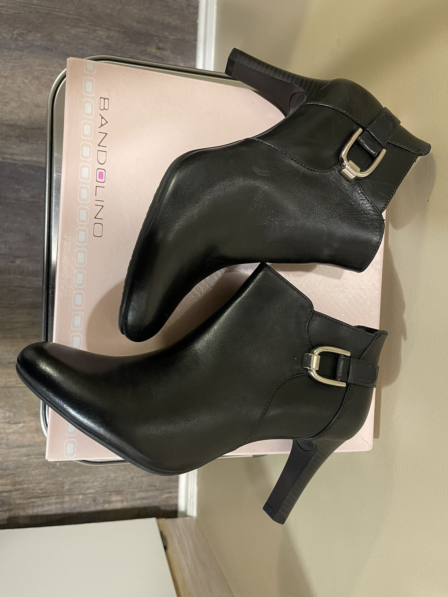 Black leather booties with side zipper and buckle detail. Heels are approximately 3 inches tall. Size 9