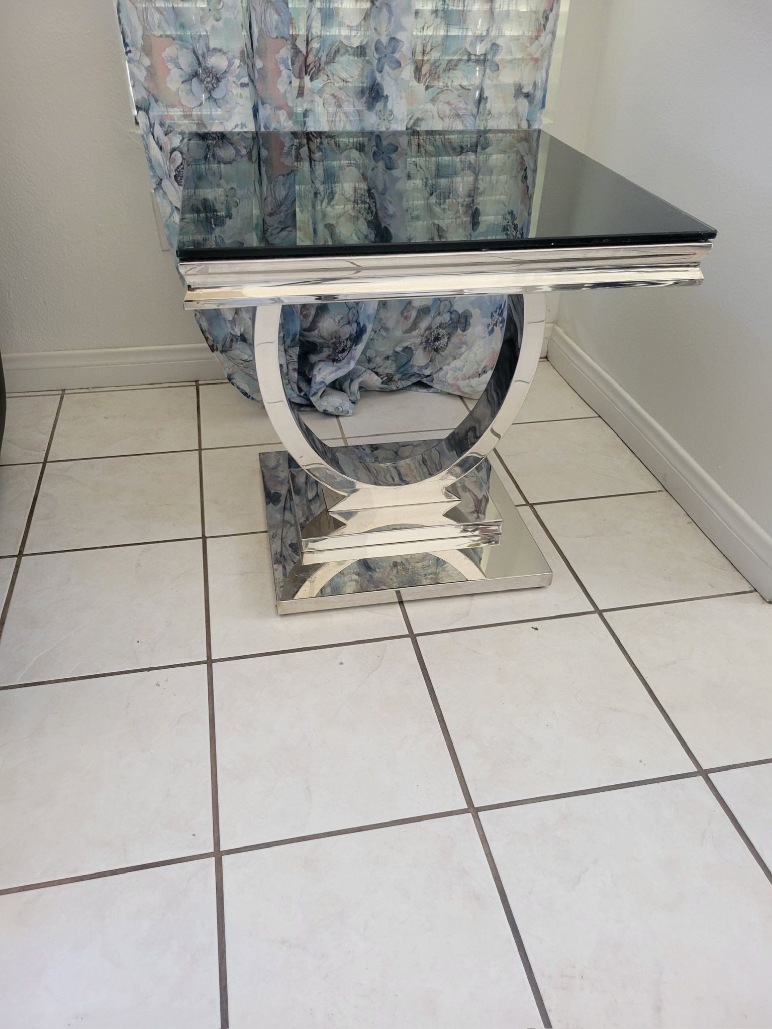 Stainless steel end table with black glass