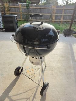 The Weber 22 In. Original Kettle Premium Charcoal Grill features a built-in lid thermometer (Delivery Available)