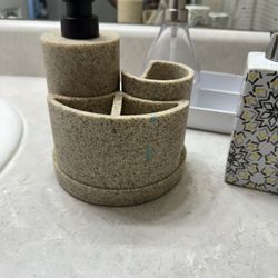 2 different soap dispensers and toothbrush holders, 2 bathroom mats, 1 dish-soap dispenser