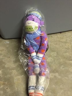 Brand new purple and orange sock monkey stuffed animal