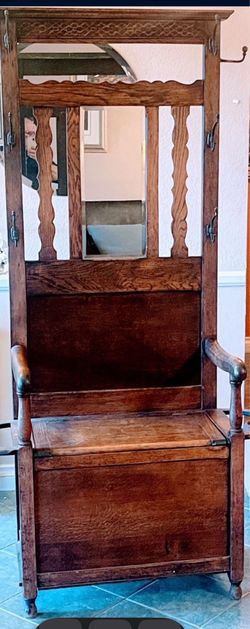 This item is an antique oak hall tree a/k/a=Antique Hat, Coat & Boot Rack